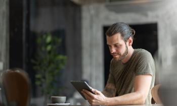 Attractive Beard man sitting using digital tablet