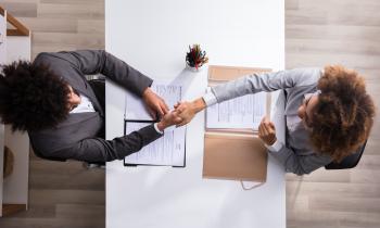 Male Manager Shaking Hands With Female Applicant Male Manager Shaking Hands With Female Applicant