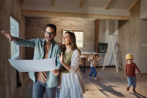 Un couple et leurs deux enfants évoluent dans une maison en construction. 