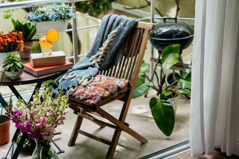 petit balcon avec plantes, table, chaise et barbecue