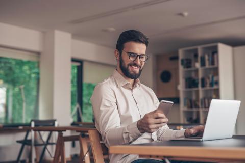 Working smiling man indoors